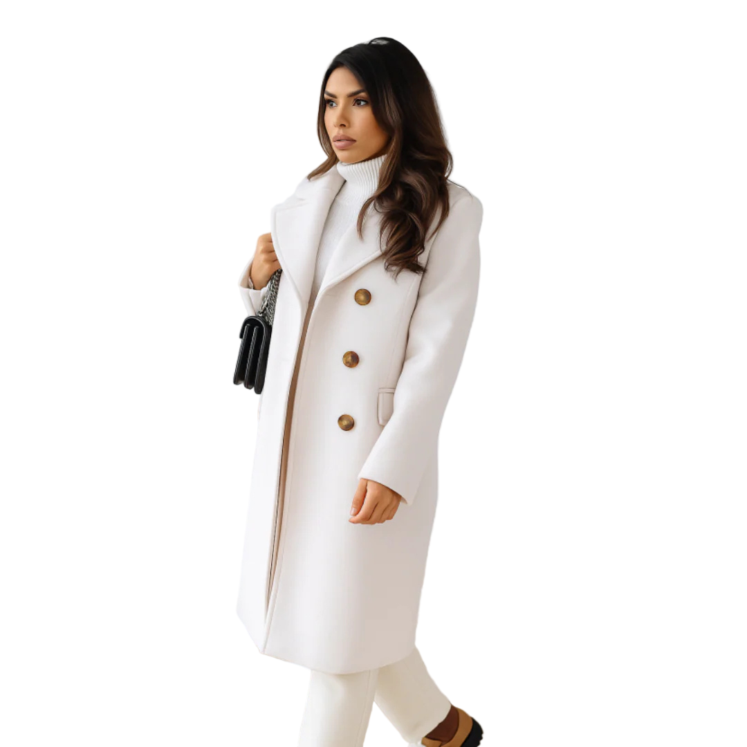 Woman wearing a white coat with gold buttons indoors.