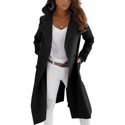 Woman wearing a black coat over a white outfit with a white background