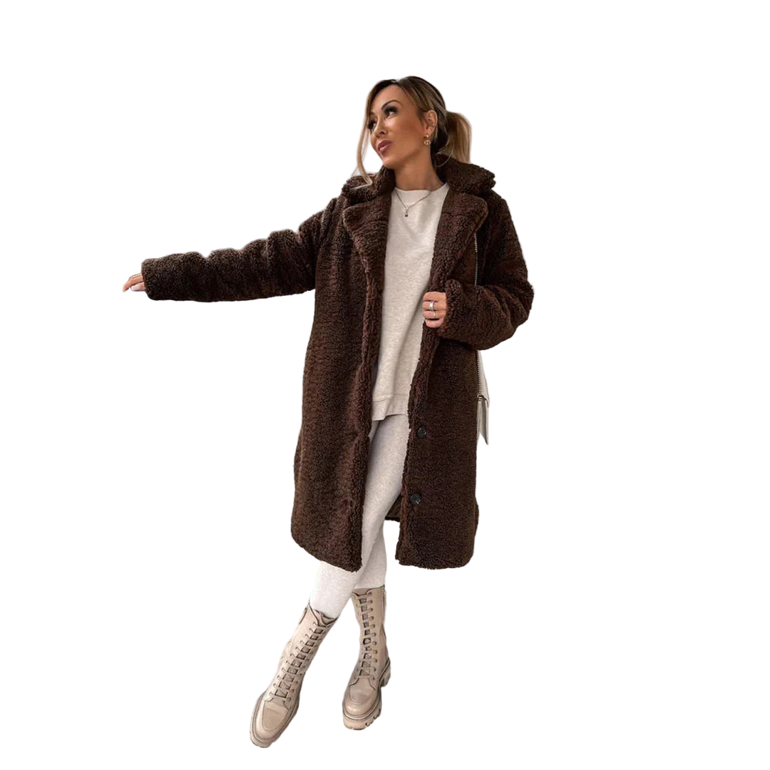 Woman in a brown coat standing on concrete stairs