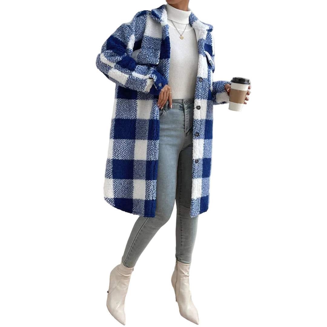 Person wearing a blue and white checkered coat holding a coffee cup indoors.