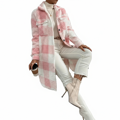 Person wearing a pink and white checkered coat with white pants and boots against a gray background