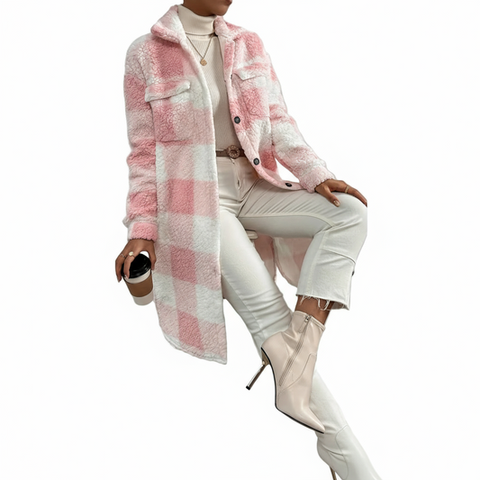 Person wearing a pink and white checkered coat with white pants and boots against a gray background